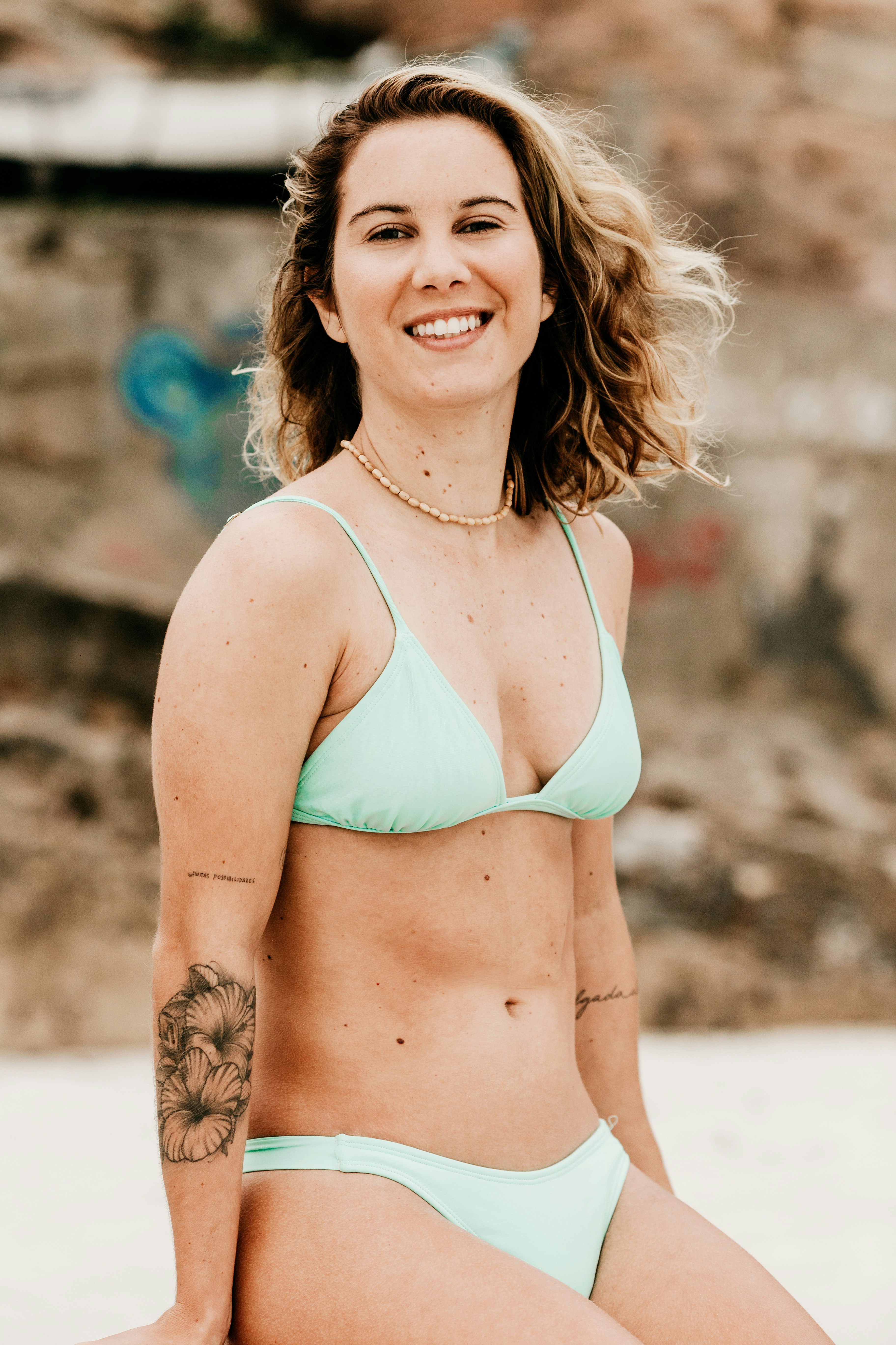 woman in green bikini top smiling